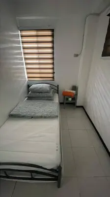 a room with two bunk beds and a window at Relaxing 3bedroom home with outdoor dining NUVALI in Calamba