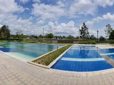 a large swimming pool with blue water at Relaxing 3bedroom home with outdoor dining NUVALI in Calamba