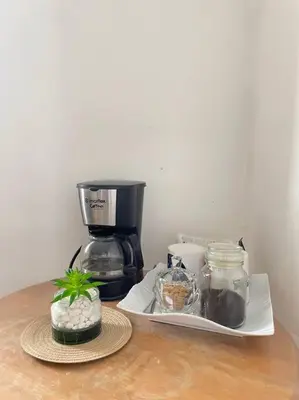 a counter with a coffee maker and a plant on it at Relaxing 3bedroom home with outdoor dining NUVALI in Calamba