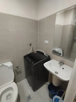 a small bathroom with a toilet and a sink at Shore D 1422 in Manila
