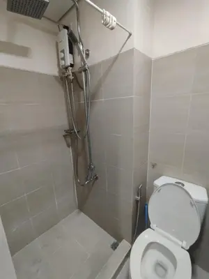 a bathroom with a shower and a toilet in it at Shore D 1422 in Manila