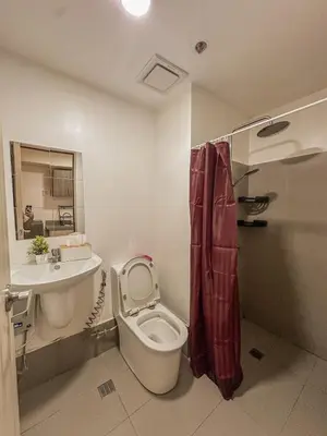 a bathroom with a toilet and a sink at Cozy Condo in Mandaluyong with Balcony, Pool &Netflix in Manila