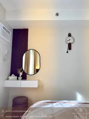 a bedroom with a mirror on the wall at Modern Sleek - Staycation in Las Piñas in Manila