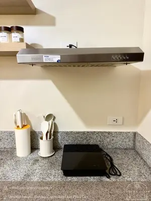 a kitchen with a counter with a stove at Modern Sleek - Staycation in Las Piñas in Manila