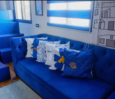 a blue couch with pillows on it in a room at Staycation Studio Type in Valley Golf in Cainta