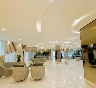 a lobby with couches and chairs in a building at Modern Taguig Staycation Near BGC in Manila