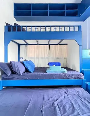 a bedroom with a blue bunk bed with a blue mattress at Valley Mansions Staycation near Taytay in Cainta