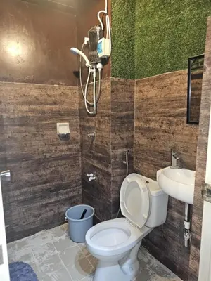 a bathroom with a toilet and a sink at Valley Golf Condominium Staycation in Cainta