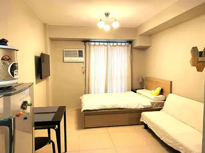 a small room with a bed and a couch at Modern Studio Condominium 1 in Manila