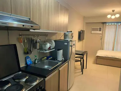 a kitchen with a sink and a stove top oven at Modern Studio Condominium 1 in Manila