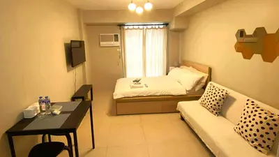 a small room with a bed and a couch at Modern Studio Condominium 1 in Manila