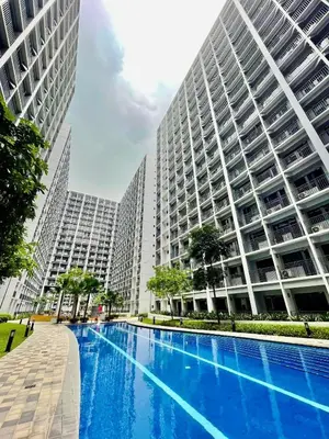 a large building with a swimming pool in front of it at Shore 2 Tower 3 SmDC Residences Condo near Mall of Asia Pasay city, Philippines in Manila