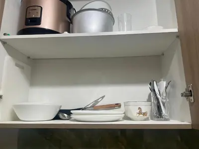 a shelf with bowls and utensils on it at Shore 2 Tower 3 SmDC Residences Condo near Mall of Asia Pasay city, Philippines in Manila
