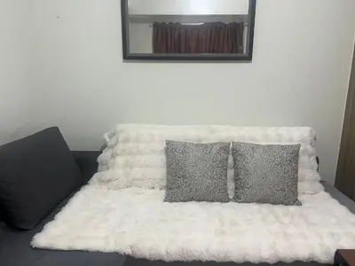 a white bed with two pillows and a mirror at Shore 2 Tower 3 SmDC Residences Condo near Mall of Asia Pasay city, Philippines in Manila