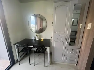 a dining room with a table and a mirror at Shore 2 Tower 3 SmDC Residences Condo near Mall of Asia Pasay city, Philippines in Manila