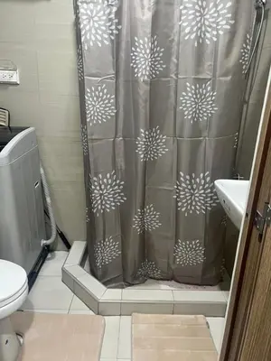 a bathroom with a shower curtain and a toilet at Shore 2 Tower 3 SmDC Residences Condo near Mall of Asia Pasay city, Philippines in Manila