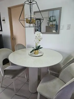 a white dining room table with chairs around it at Cozy 3-Bedroom Family Condo in Manila