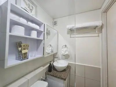 a bathroom with a toilet and a sink and a shower at Cozy 3-Bedroom Family Condo in Manila