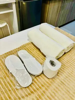 a pair of flip flops and towels on a counter at Shore 2 Residences in Manila
