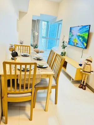 a dining room with a wooden table and chairs at Andi and Frances Place at BGC in Manila