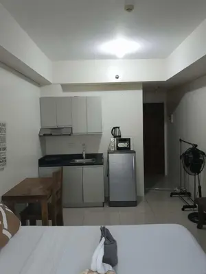 a small kitchen with a sink and a table at The Beacon Makati Condo-Hotel in Manila