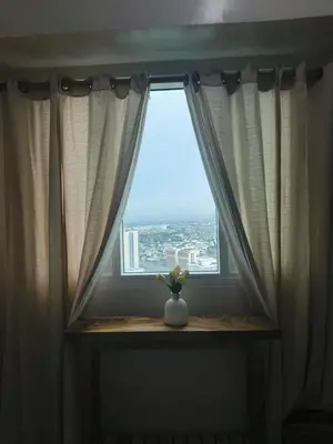 a window with a vase sitting on a window sill at The Beacon Makati Condo-Hotel in Manila