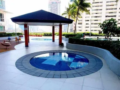 a gazebo with a blue pond in a courtyard at The Beacon Makati Condo-Hotel in Manila