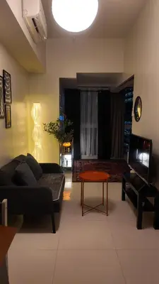 a living room with a couch and a table at Cozy place in Uptown BGC near Malls and clubs in Manila