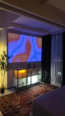 a living room with a large screen in a room at Cozy place in Uptown BGC near Malls and clubs in Manila