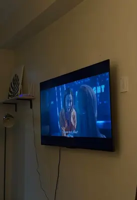 a flat screen tv hanging on a wall at CabinandCo in Manila