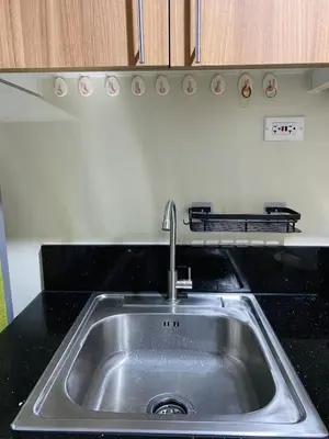 a stainless steel sink in a kitchen at CabinandCo in Manila