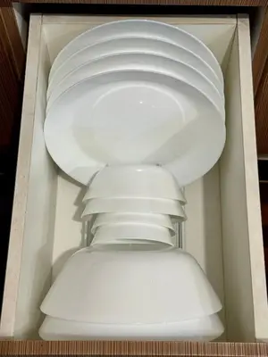 a white drawer filled with white plates and bowls at Newport Stay Walk to NAIA T3 in Manila