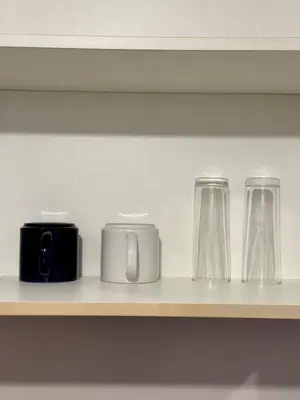 a shelf with three glasses and a camera on it at Newport Stay Walk to NAIA T3 in Manila