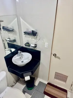 a bathroom with a sink and a toilet at Newport Stay Walk to NAIA T3 in Manila