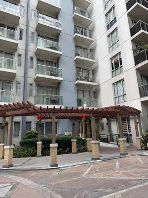 a building with a pavilion in front of it at Newport Stay Walk to NAIA T3 in Manila