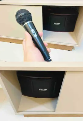 a person holding a microphone in a drawer at FREE Parking City lights AlexaVoice Control Unit in Manila