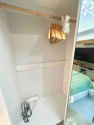 a mirror in a small room with a bed at FREE Parking City lights AlexaVoice Control Unit in Manila