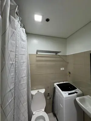 a small bathroom with a toilet and a sink at Metro Prime Staycations at Shore 2 Residences T1 in Manila