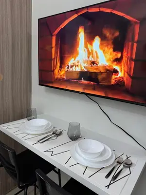 a table with two plates and a fireplace at Metro Prime Staycations at Shore 2 Residences T1 in Manila