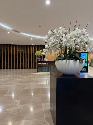 a large white vase with white flowers in a lobby at Metro Prime Staycations at Shore 2 Residences T1 in Manila