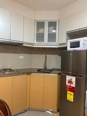 a kitchen with a sink and a refrigerator at 3ms and jacob havens in Manila