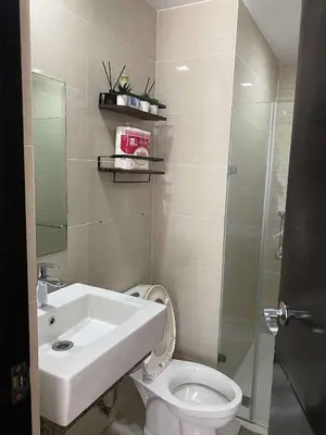 a bathroom with a sink and a toilet and a shower at 3ms and jacob havens in Manila