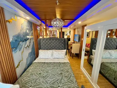 a room with a bed and a wall with a map at J&J Havenstay Ananda Square in Manila