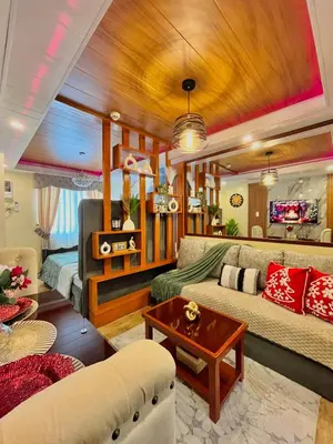 a living room with a couch and a table at J&J Havenstay Ananda Square in Manila
