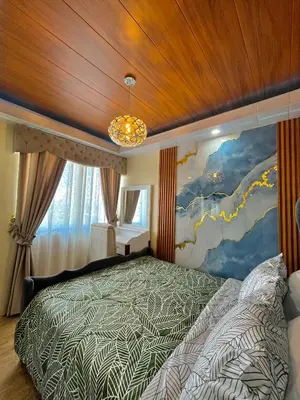 a bedroom with a bed with a painting on the wall at J&J Havenstay Ananda Square in Manila