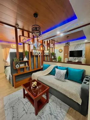 a living room with a couch and a table at J&J Havenstay Ananda Square in Manila