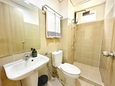a bathroom with a toilet and a sink at Spacious 2BR Living Rm Shore Res near NAIA MOA in Manila
