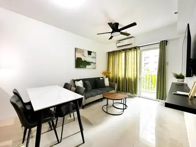 a living room with a couch and a table at Spacious 2BR Living Rm Shore Res near NAIA MOA in Manila