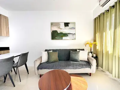 a living room with a couch and a table at Spacious 2BR Living Rm Shore Res near NAIA MOA in Manila