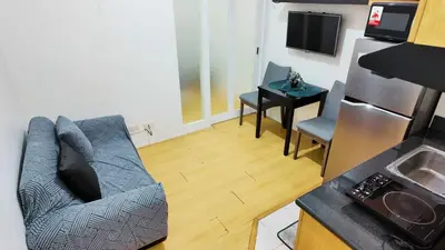 a living room with a couch and a table at Monitor Gear Residences in Manila